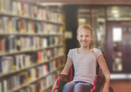 Digital composite of Disabled girl in wheelchair in school libraryの写真素材