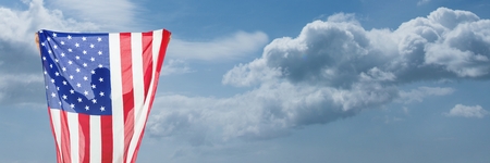 Digital composite of Man holding USA flag against sky background