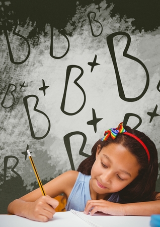 Digital composite of Student girl at table writing against green blackboard with school and education graphicの写真素材