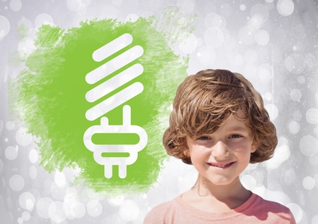 Digital composite of Boy next to light bulb green energyの写真素材