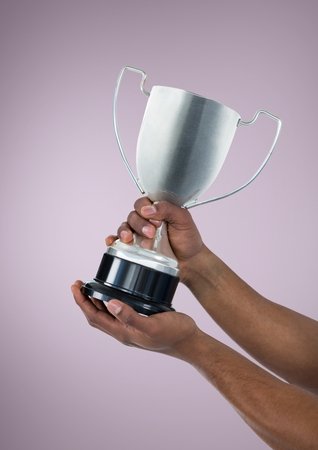 Digital composite of Person holding a trophy on handsの写真素材