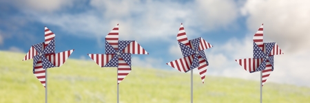 Digital composite of USA wind catchers in front of sky and grassの写真素材