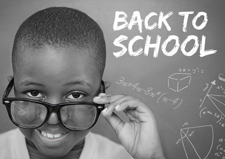 Digital composite of Back to school text on blackboard with boy