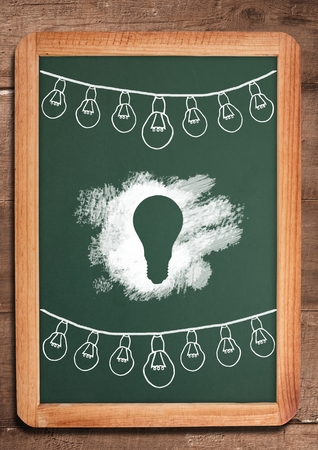 Digital composite of light bulbs on blackboardの写真素材