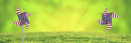 Digital composite of USA wind catchers in front of grass