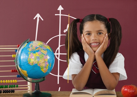 Digital composite of Student girl at table against red blackboard with school and education graphic