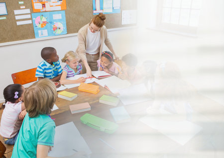 Digital composite of Elementary school teacher teacher with classの写真素材