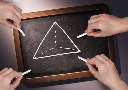 Digital composite of Hands drawing pyramid on blackboard
