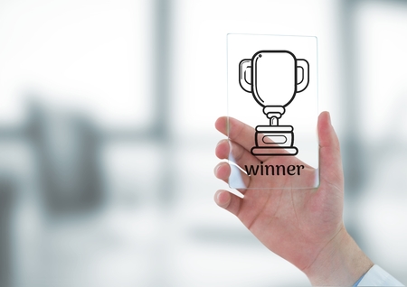 Digital composite of Hand holding a glass with a trophy iconの写真素材