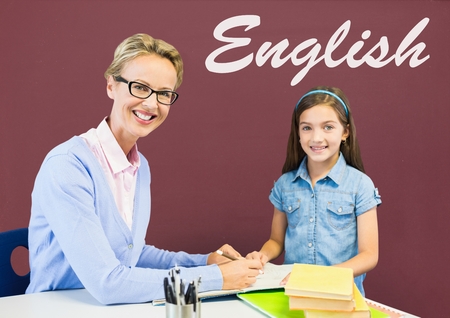 Digital composite of Student girl and teacher at table against red blackboard with English textの写真素材