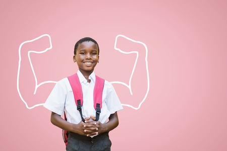 Digital composite of Happy student boy with fists graphic standing against pink backgroundの写真素材