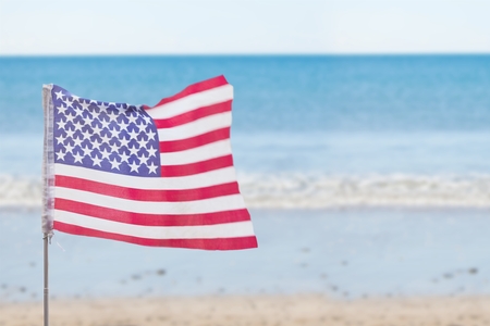 Digital composite of USA flag in the beachの写真素材