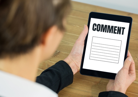 Digital composite of Comment text and graphic on tablet screen with handsの写真素材