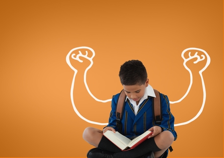 Digital composite of Student boy with fists graphic reading against orange backgroundの写真素材