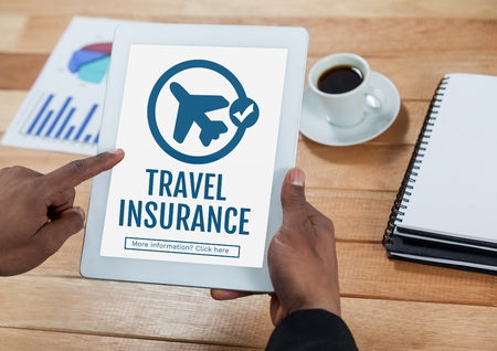 Digital composite of Person using a tablet with travel insurance concept on screenの写真素材
