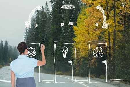 Digital composite of Business woman drawing doors on the roadの写真素材