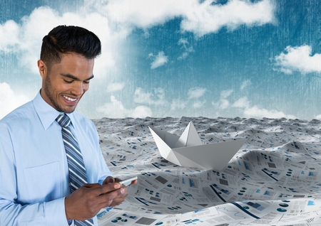 Digital composite of Businessman on phone in sea of documents under sky cloudsの写真素材