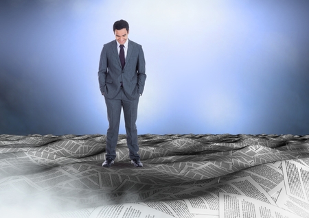 Digital composite of Businessman in sea of documents under sky cloudsの写真素材