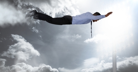 Digital composite of Businessman flying in illuminated sky