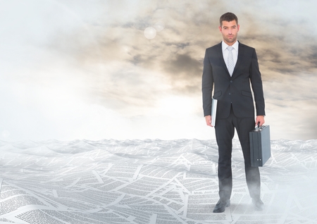 Digital composite of Businessman holding briefcase in sea of documents under sky cloudsの写真素材