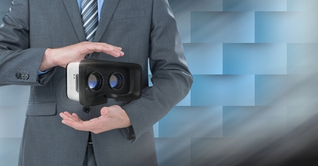 Digital composite of Hands holding and interacting with virtual reality headset with transition effectの写真素材