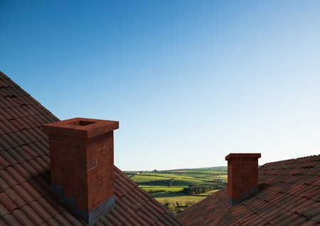 Digital composite of Roofs with chimney and green country landscapeの写真素材