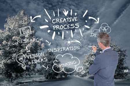 Digital composite of Business man drawing graphics on the roadの写真素材