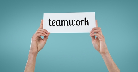 Digital composite of Business woman holding a card with teamwork textの写真素材