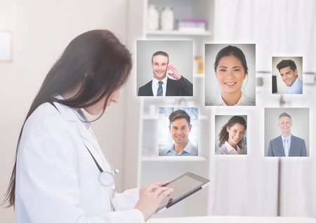Digital composite of Woman holding laptop with Profile portraits of people contactsの写真素材