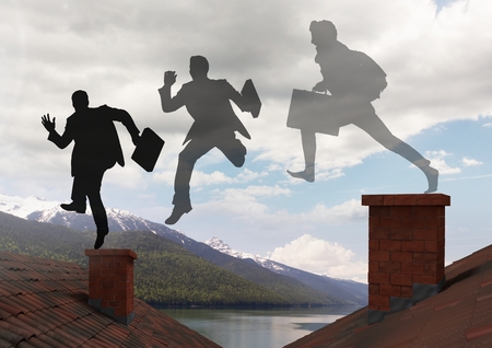 Digital composite of Businessman silhouettes with briefcase jumping on Roofs with chimney and mountain lake landscapeの写真素材