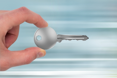 Digital composite of Hand holding keysの写真素材