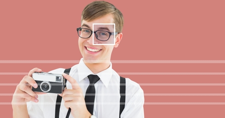 Digital composite of man holding camera with eye focus box detail over glasses and linesの写真素材