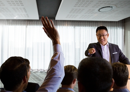 Digital composite of Businessman speaking at conference with businesspeople
