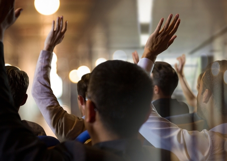 Digital composite of Business people with hands raised up at conferenceの写真素材