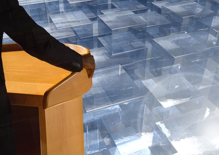 Digital composite of Businessman on podium speaking at conference with glass cubesの写真素材