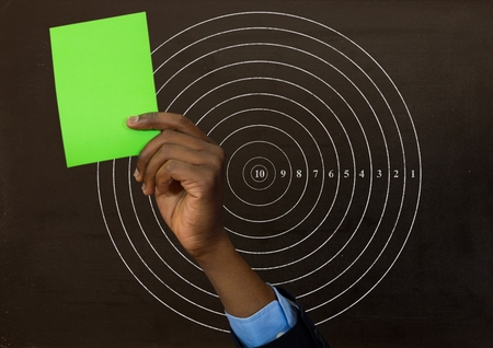 Digital composite of Hand holding green card in front of circle radius numbersの写真素材