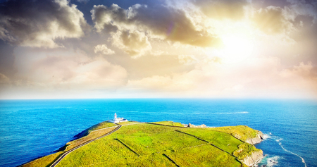 Scenic view of sea and hill against skyの写真素材
