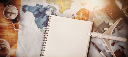 Directly above shot of diary with map and camera on table