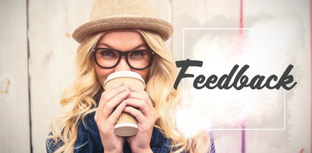 Feedback text against white background  against portrait of smiling fashionable woman drinking coffee outdoorsの写真素材