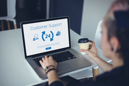 Icons and customer support text against woman using laptop
