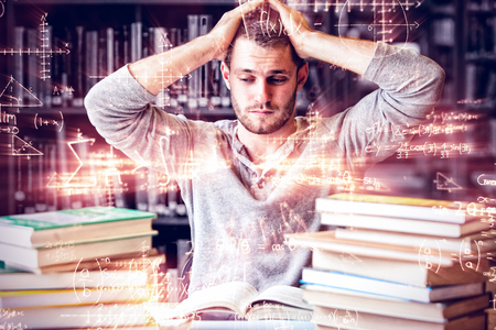 Tired student having too much to do in library