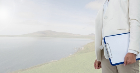 Digital composite of Businesswoman in nature on beachの写真素材