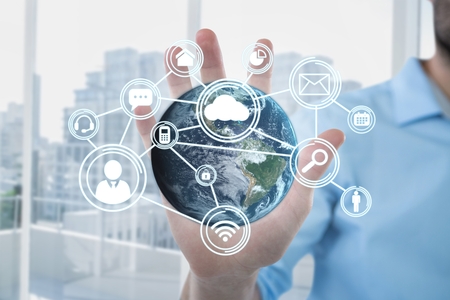 Digital composite of Business man holding a globe with connectors