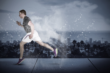 Muscular rugby player running  against digitally generated image of blue color powderの写真素材