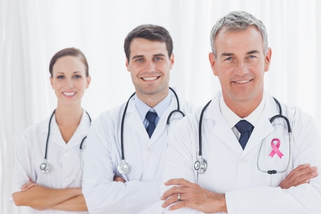 Digital composite of Doctors with breast cancer awareness ribbonの写真素材
