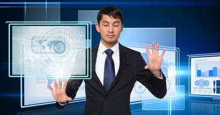 Digital composite of Businessman touching and interacting with technology interface panelsの写真素材