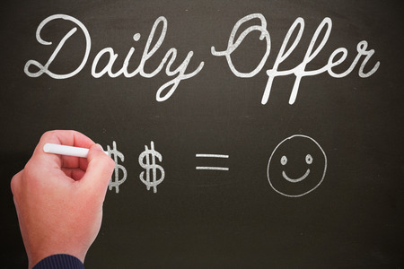 Hand writing with chalk against blackboardの写真素材