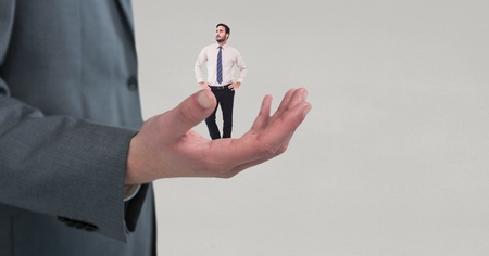 Digital composite of Small business man on the big business man handの写真素材