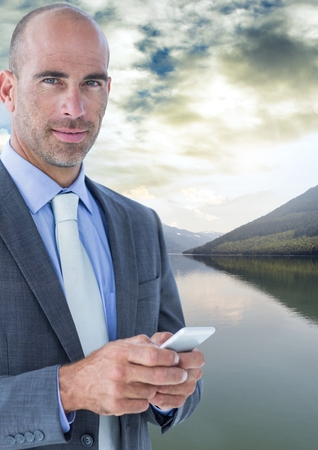 Digital composite of Businessman in nature lakeの写真素材