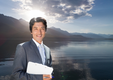 Digital composite of Businessman in nature lakeの写真素材